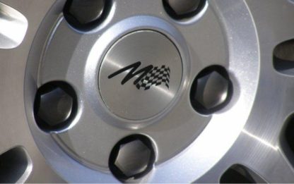 Kryt emblému Alu kola  s vypískovaným  M-logem